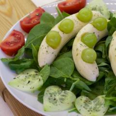 Grapes on bananas at baby spinach